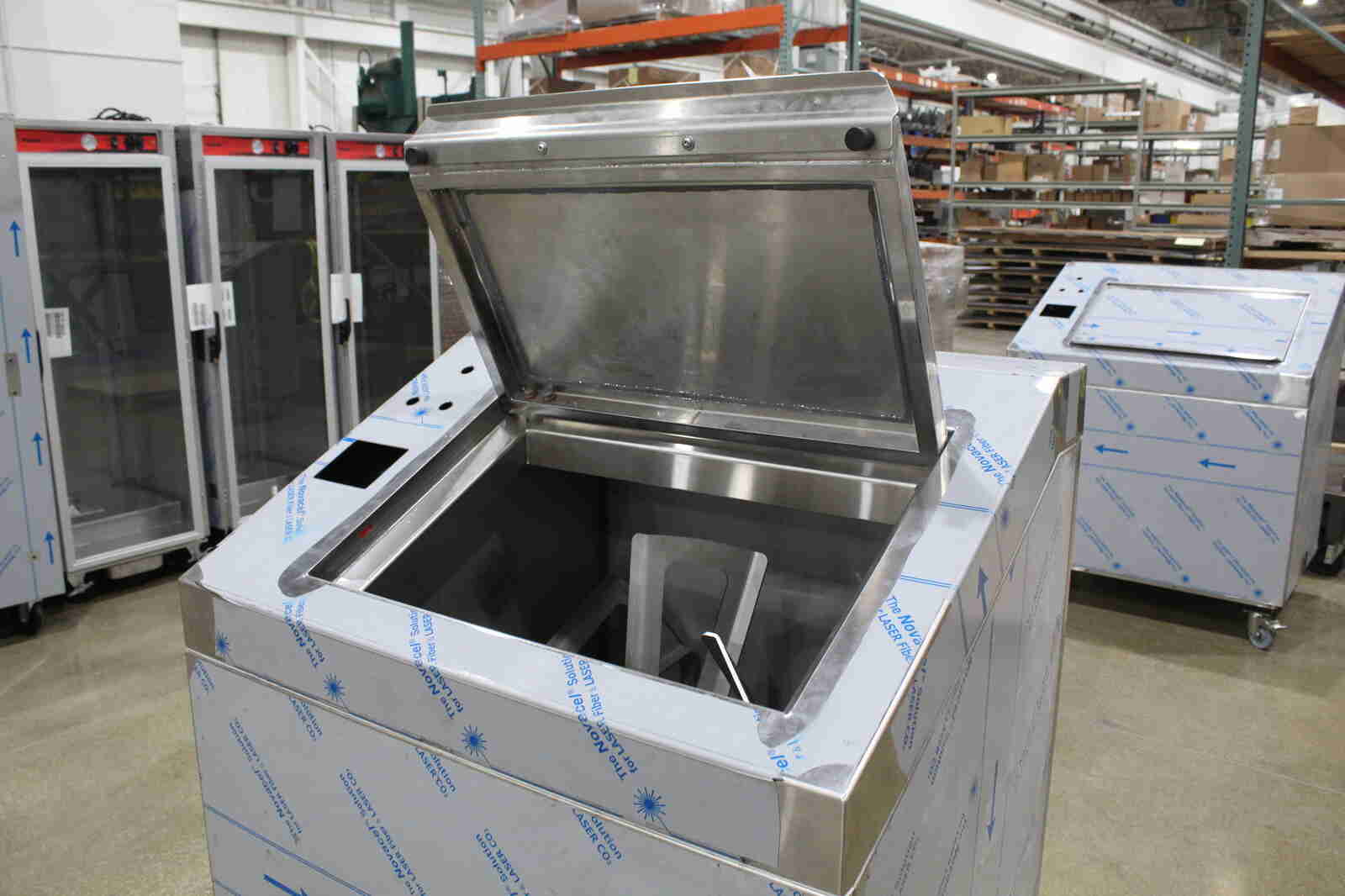 Close up front view of an open stainless steel food service biodigester