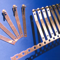 Stamped copper electrical contact with in-die insertion for the automotive industry