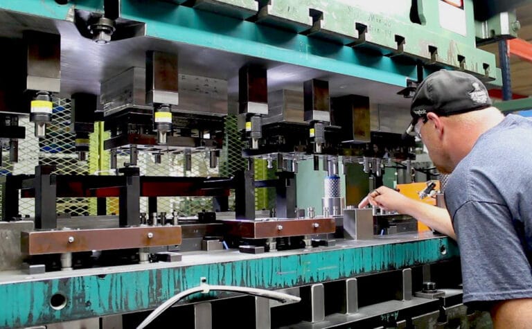 WMP Employee inspecting a Progressive Stamping Die in the prototyping stage